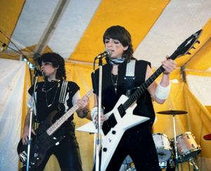Justin Fisher and Rivers Cuomo in Kiss-like make up, performing at